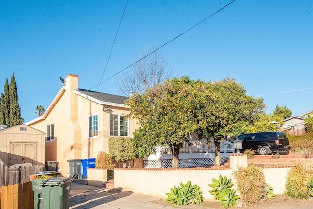 view of property exterior with a shed