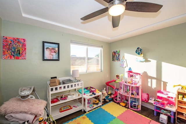 rec room with ceiling fan and dark hardwood / wood-style flooring