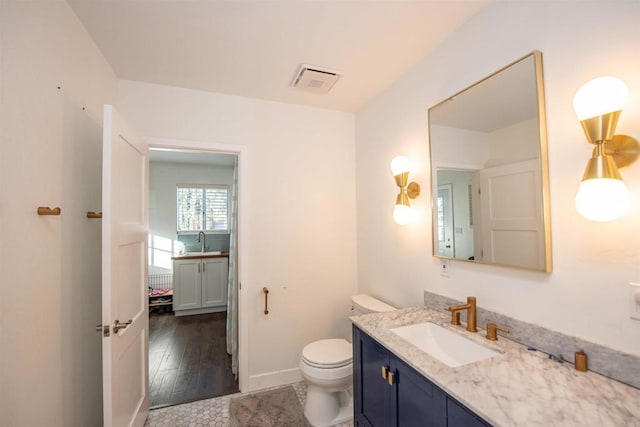 bathroom featuring vanity and toilet