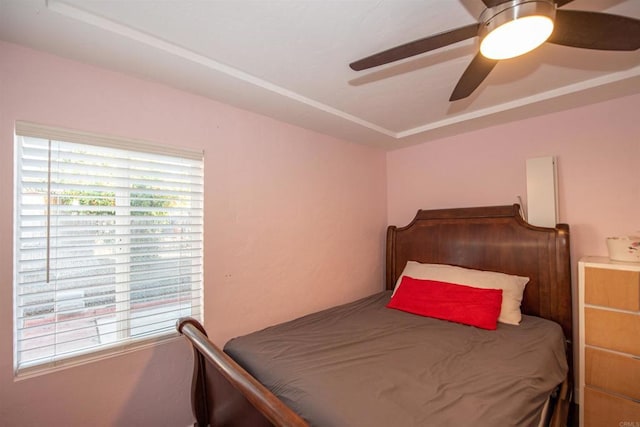 bedroom with ceiling fan and multiple windows