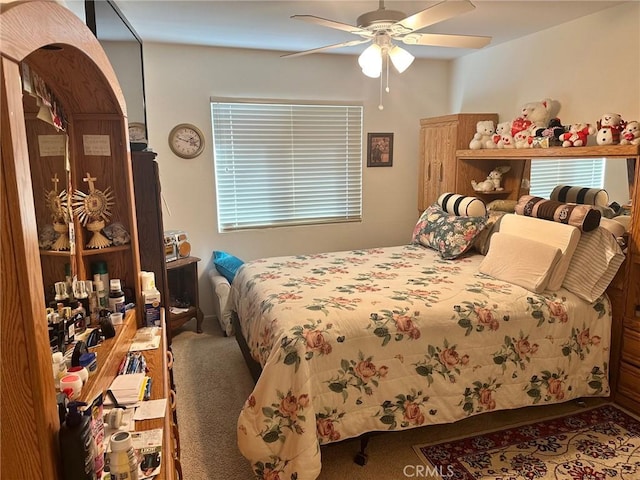 bedroom with ceiling fan and carpet flooring