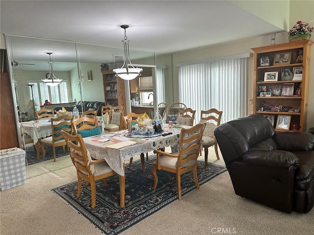 dining area featuring light carpet