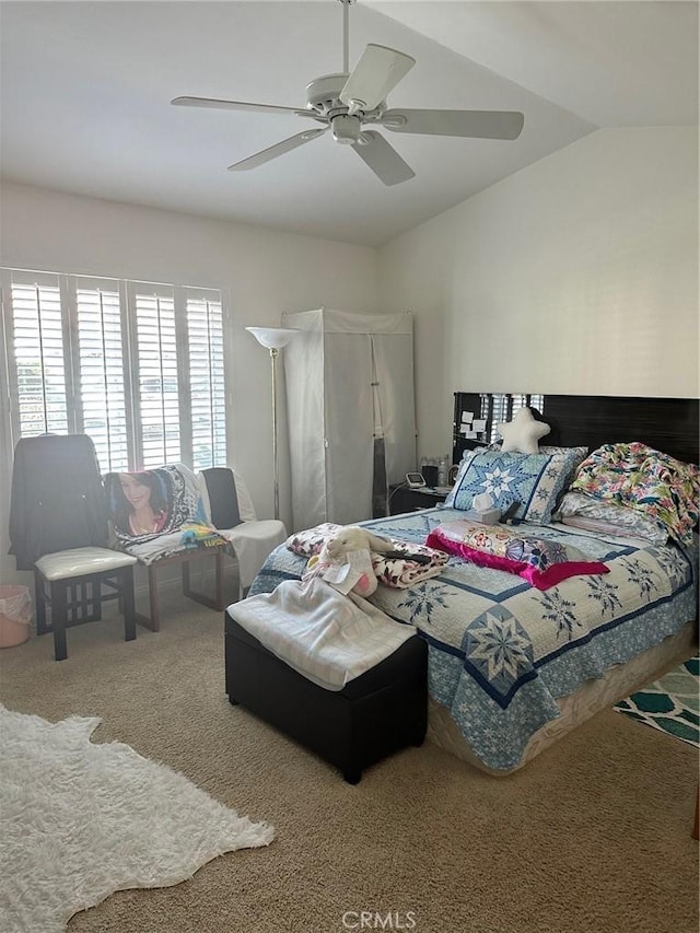 carpeted bedroom featuring vaulted ceiling and ceiling fan