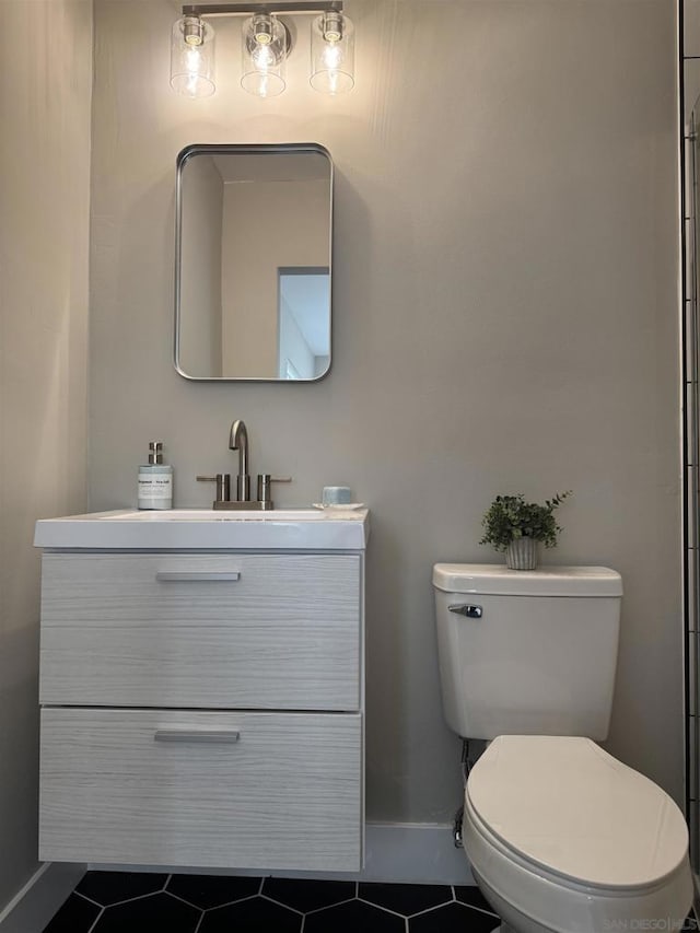 bathroom with vanity, tile patterned floors, and toilet