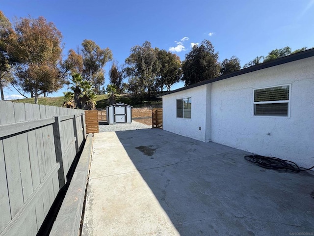 view of patio with a storage shed