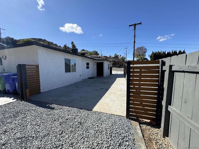 view of side of home with a patio