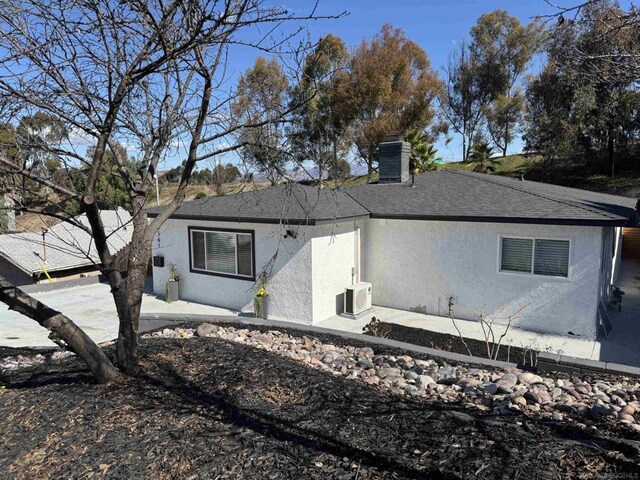 back of house featuring a patio, ac unit, and central air condition unit