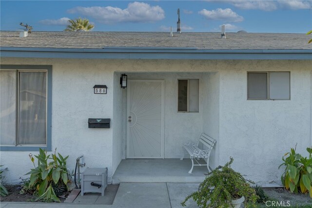 property entrance featuring a patio