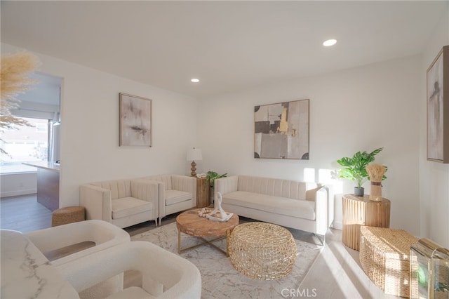 living room with light wood finished floors and recessed lighting