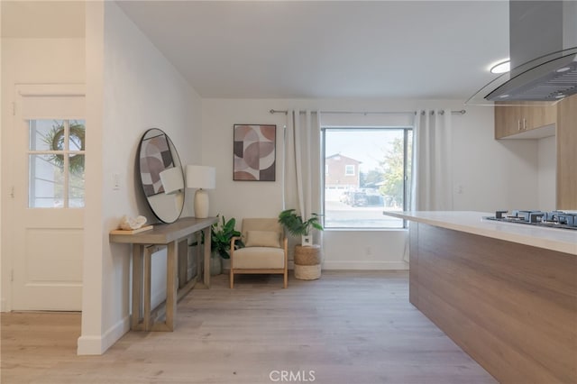 living area with light wood-style floors and baseboards