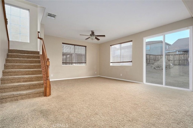 unfurnished living room featuring ceiling fan and carpet floors