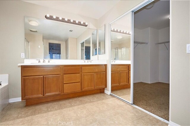 bathroom with vanity and a bath