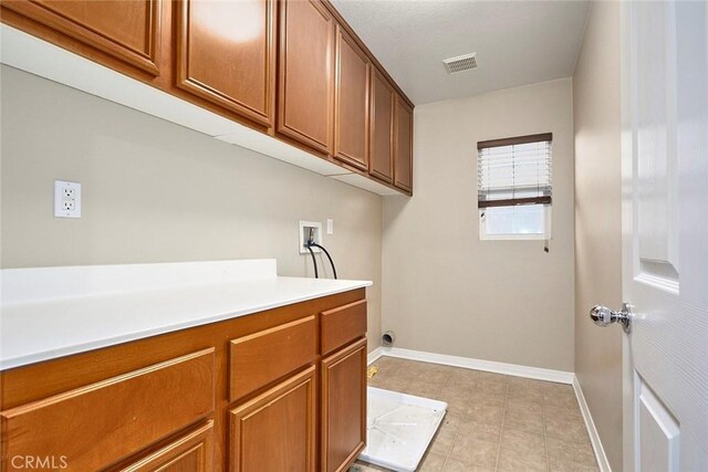 washroom with washer hookup and cabinets