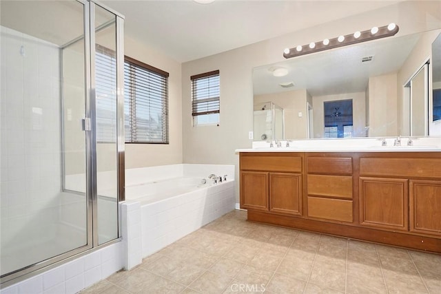 bathroom featuring independent shower and bath and vanity