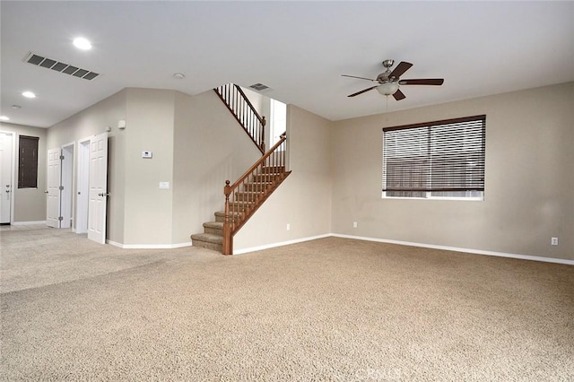 spare room featuring carpet floors and ceiling fan