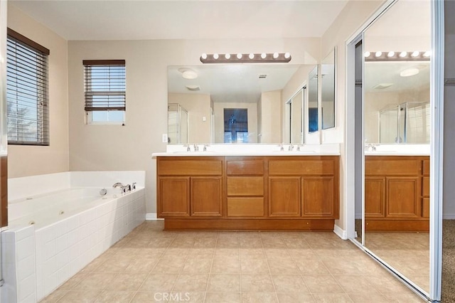 bathroom featuring vanity and a relaxing tiled tub