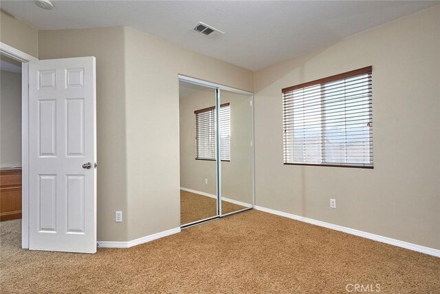 unfurnished bedroom featuring a closet and carpet