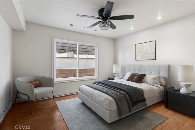 bedroom featuring light hardwood / wood-style floors and ceiling fan