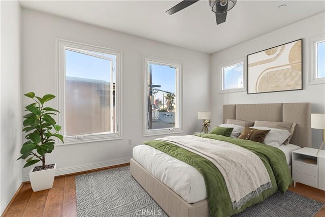 bedroom with hardwood / wood-style flooring and ceiling fan