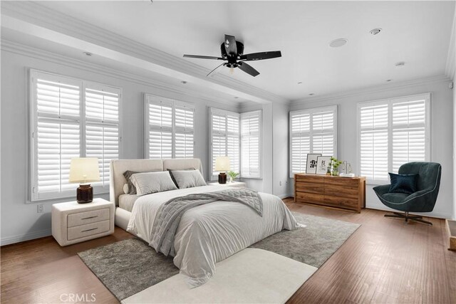 bedroom featuring crown molding and light hardwood / wood-style floors