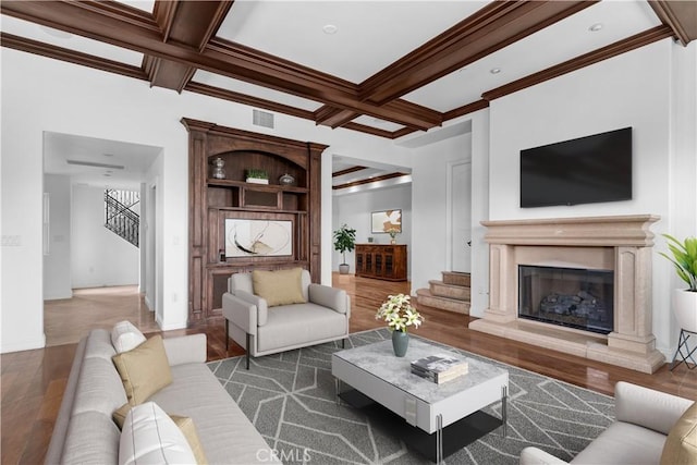 living room with coffered ceiling, crown molding, dark wood-type flooring, and beamed ceiling