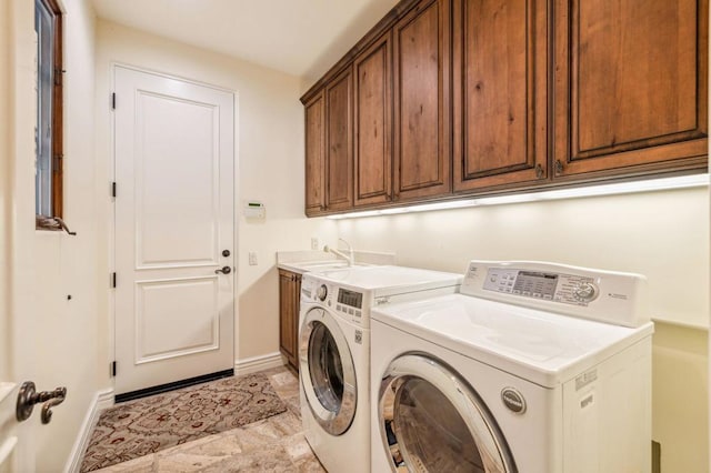 washroom with independent washer and dryer, cabinets, and sink