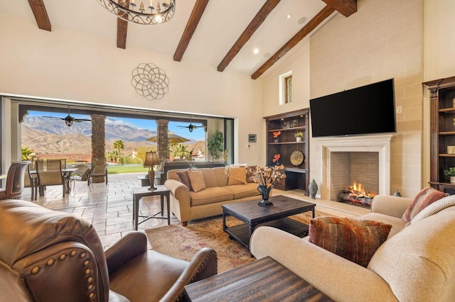 living room featuring a fireplace, high vaulted ceiling, and beamed ceiling