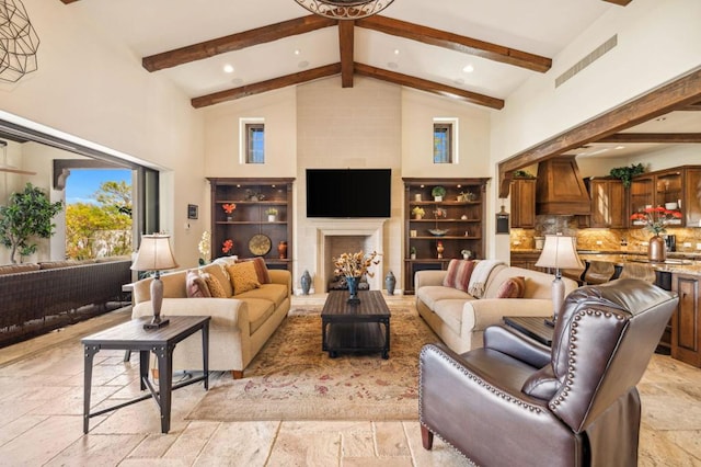 living room with a large fireplace, beam ceiling, and high vaulted ceiling