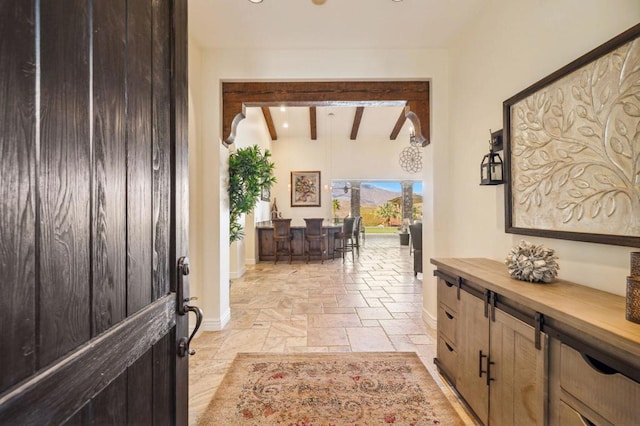 foyer entrance featuring beamed ceiling