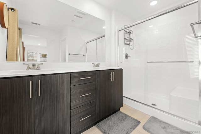 bathroom featuring an enclosed shower, vanity, and tile patterned floors