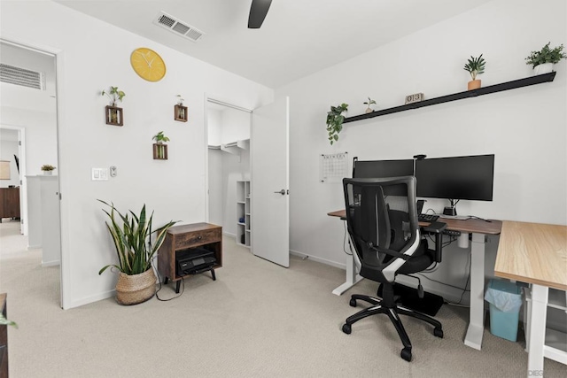 carpeted home office with ceiling fan