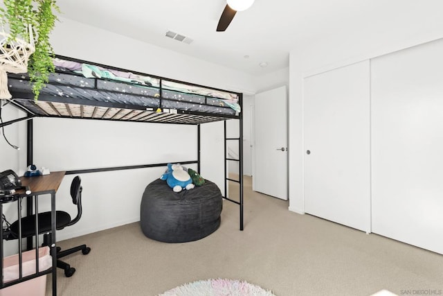 bedroom with light colored carpet, a closet, and ceiling fan