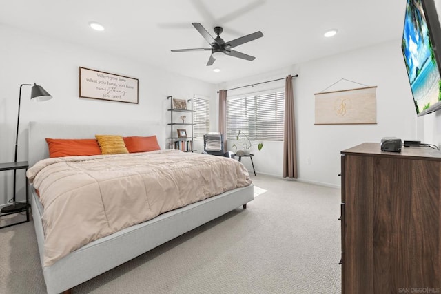 bedroom featuring light colored carpet and ceiling fan