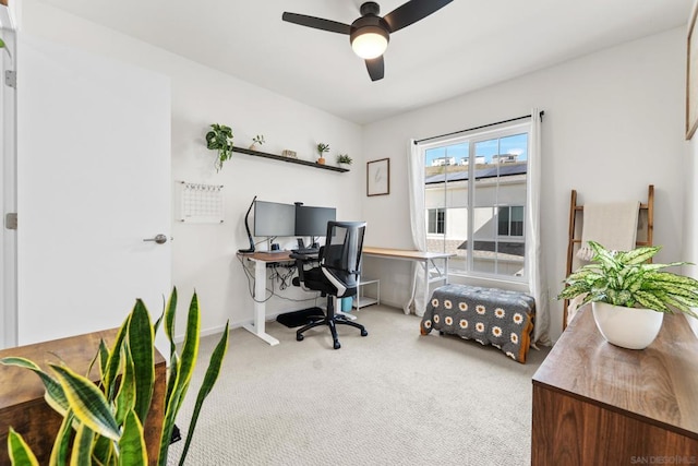 carpeted office space featuring ceiling fan