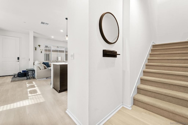 staircase featuring hardwood / wood-style flooring