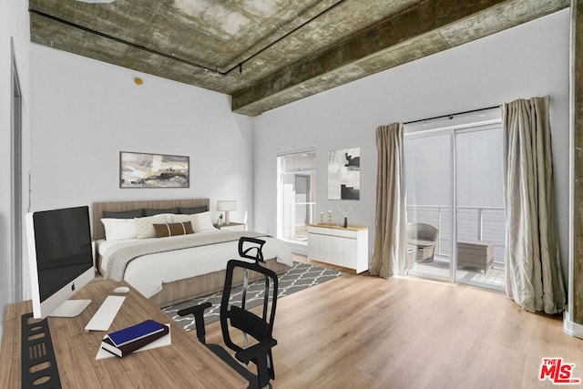 bedroom featuring access to exterior and hardwood / wood-style floors