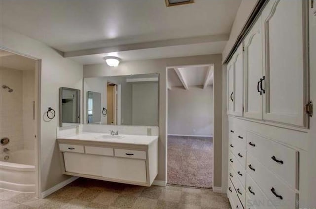 bathroom featuring vanity, beamed ceiling, and shower / bath combination