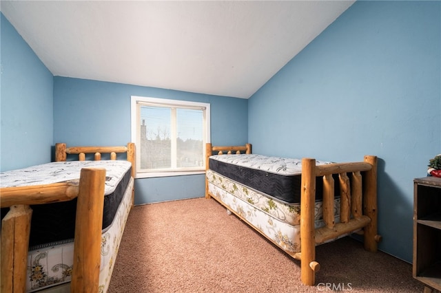 bedroom with lofted ceiling and carpet floors