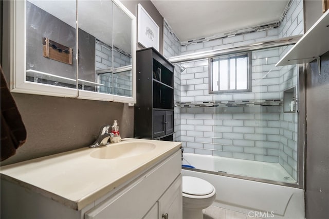 full bathroom with vanity, shower / bath combination with glass door, and toilet