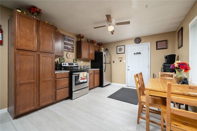 kitchen with ceiling fan, appliances with stainless steel finishes, and light hardwood / wood-style floors