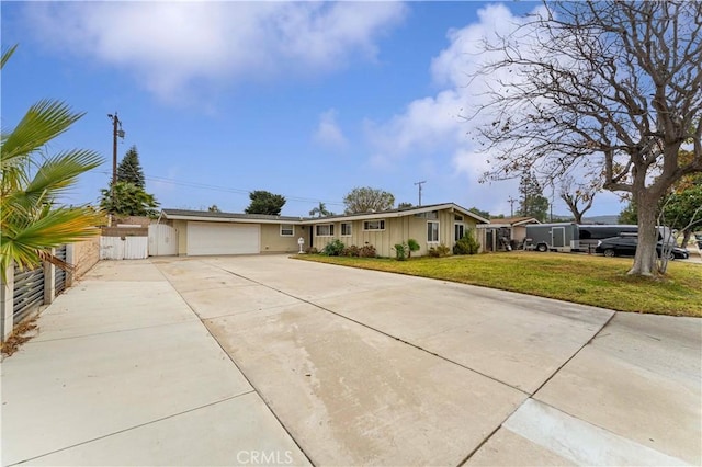 single story home with a garage and a front lawn