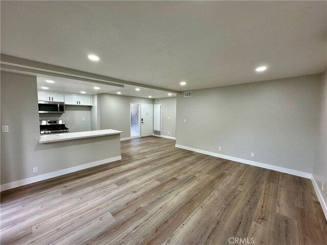 unfurnished living room featuring light wood-type flooring