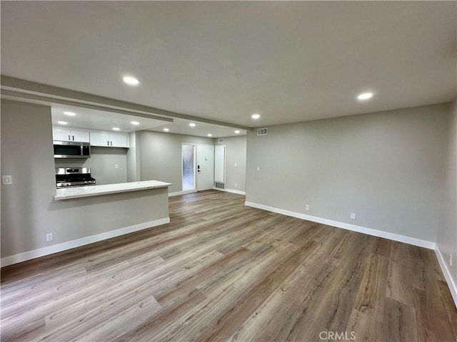 unfurnished living room featuring light hardwood / wood-style flooring