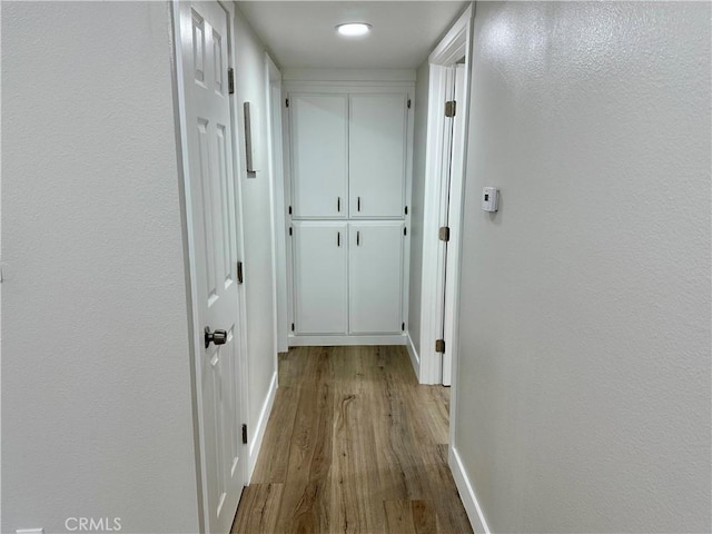 hall with light wood-type flooring