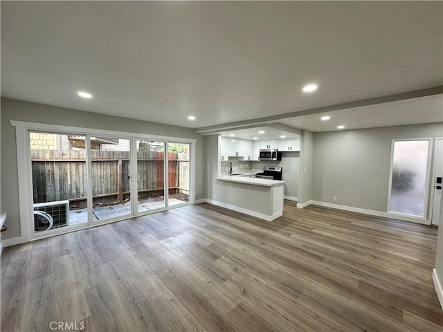 unfurnished living room featuring wood-type flooring