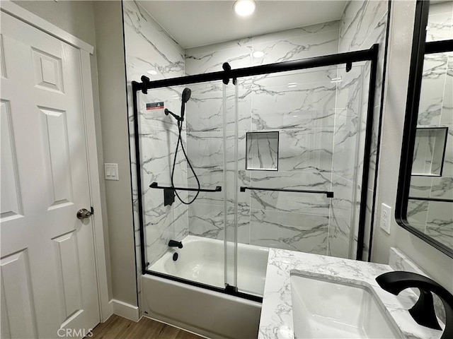 bathroom featuring vanity, shower / bath combination with glass door, and hardwood / wood-style floors