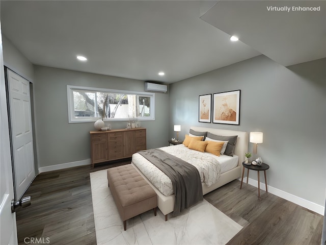 bedroom featuring dark hardwood / wood-style floors and a wall unit AC