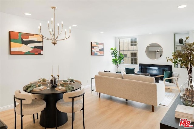 dining room with a fireplace and light wood-type flooring