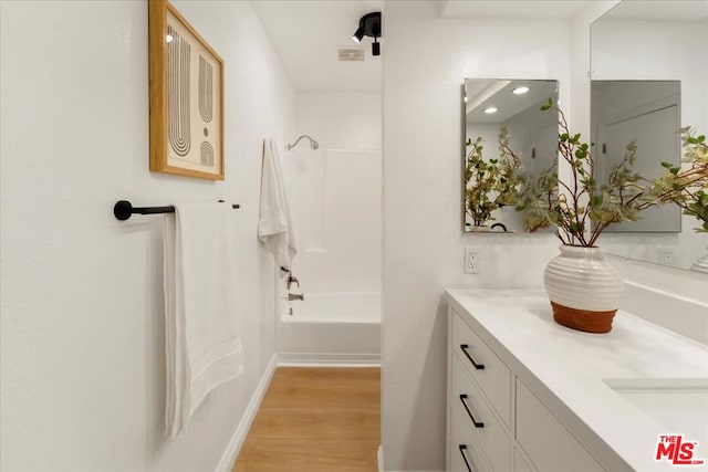 bathroom featuring vanity, tub / shower combination, and hardwood / wood-style floors