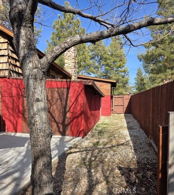 view of outbuilding with fence